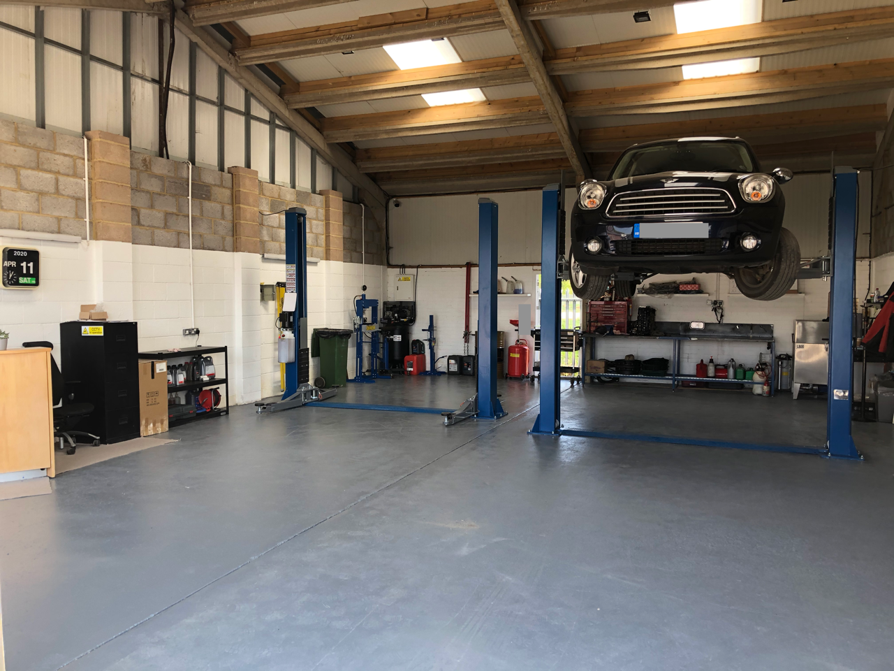 view of the garage with a car on the ramp