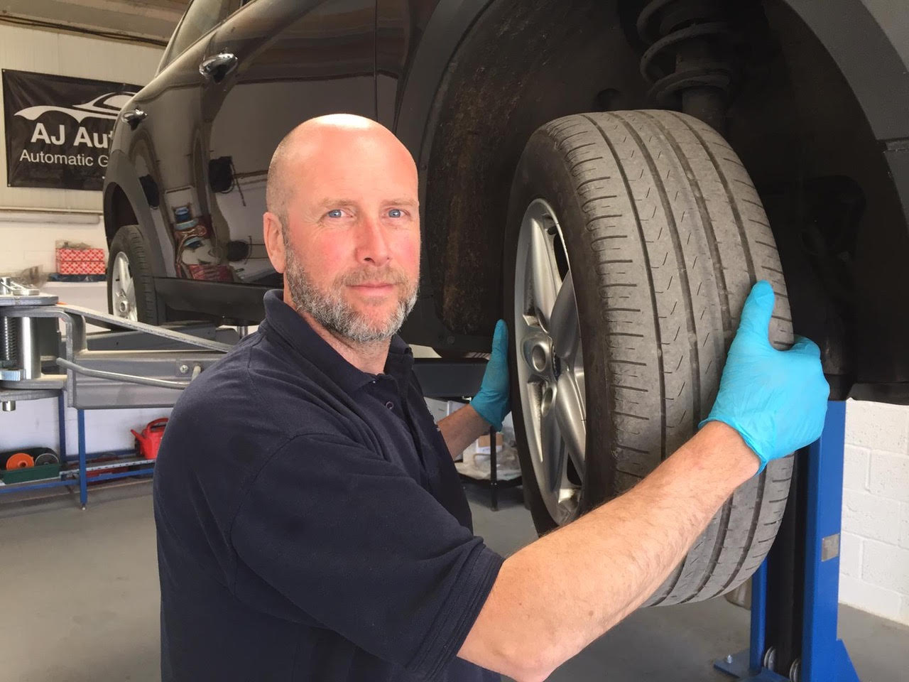 mechanic working on the tyres of a car