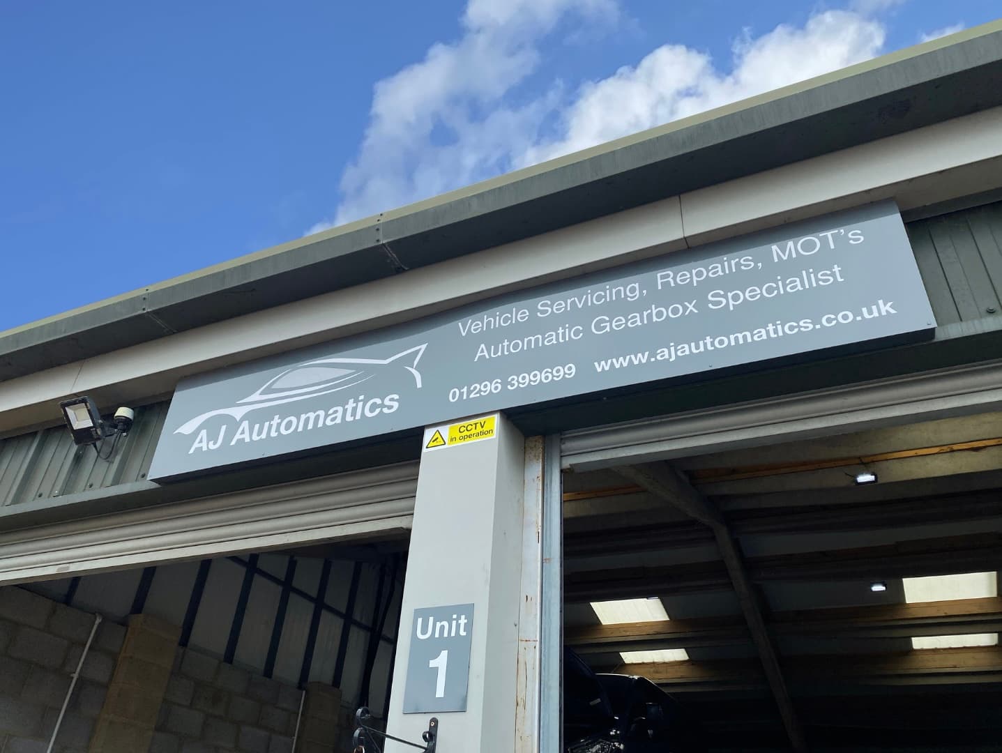 View of the garage with a car on the ramp
